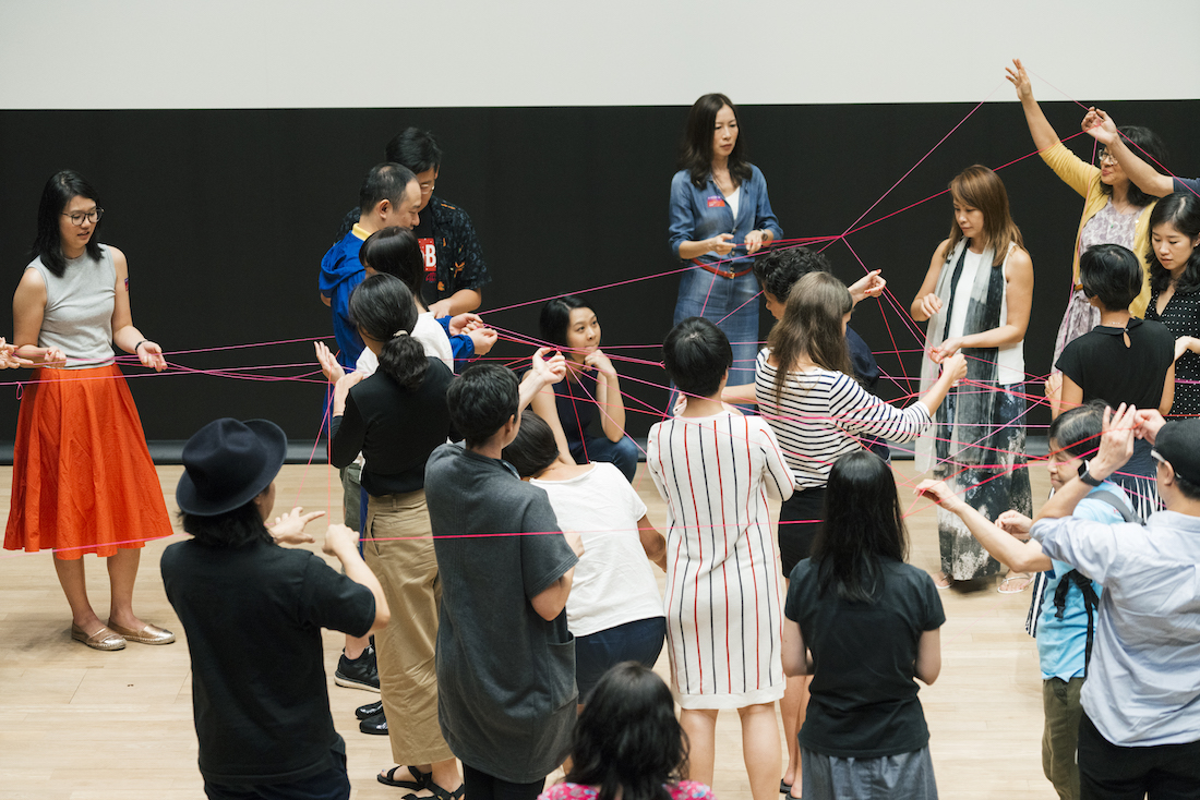 Group of people holding strings in a theater